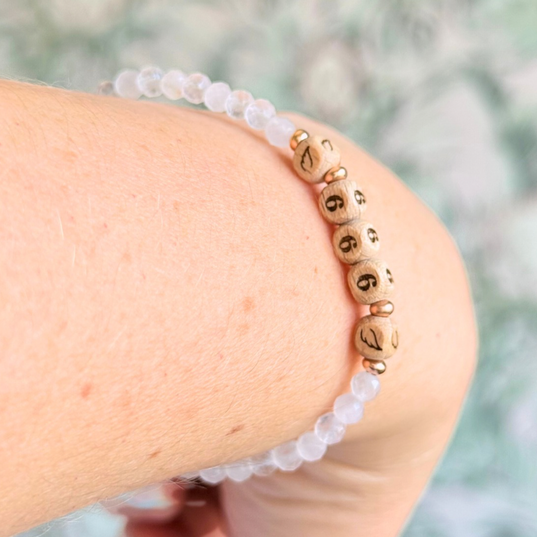 Bracelet featuring engraved wooden 666 angel number and wing beads, on the band of 4mm faceted rose quartz round crystal gemstone beads. Finished with your choice of gold vermeil, sterling silver or rose gold vermeil accent beads.