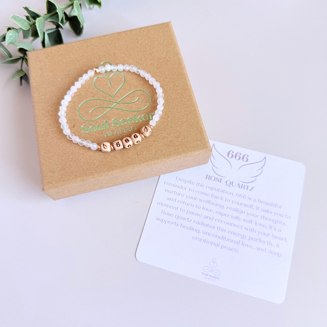 Bracelet featuring engraved wooden 666 angel number and wing beads, on the band of 4mm faceted rose quartz round crystal gemstone beads. Finished with your choice of gold vermeil, sterling silver or rose gold vermeil accent beads.