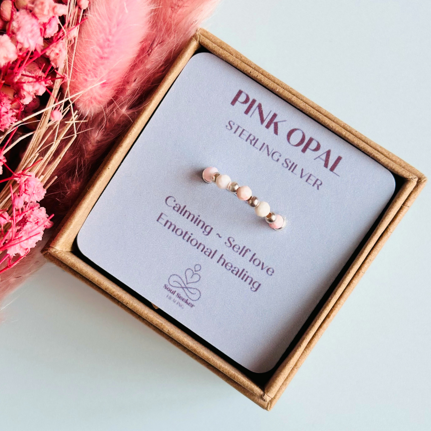 Birthstone ring featuring 5 3mm. Faceted Peruvian pink opal beads on an elasticated band of 3mm sterling silver round beads, pink opal is an October birth stone so this makes a perfect October birthday gift.