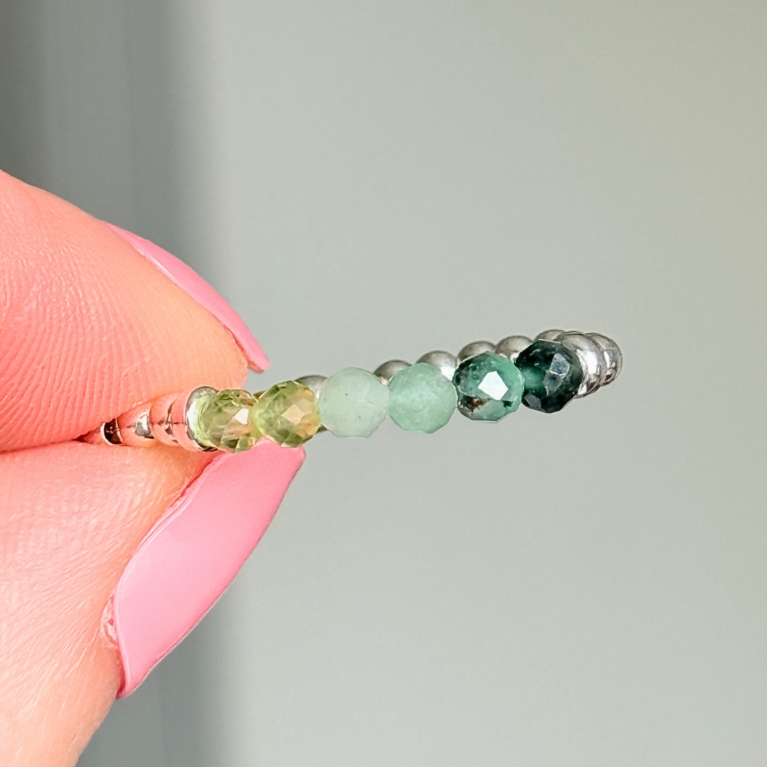 Sterling silver band style ombré ring with multicolour 3mm faceted peridot, green aventurine and emerald beads with a beaded band of 2.5 mm sterling silver round beads. Elasticated for comfort.