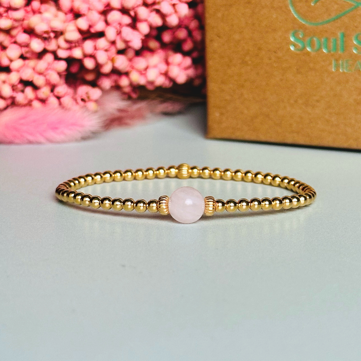 Gold vermeil rose quartz bracelet features an ethically mined 8mm rose quartz bead, flanked by corrugated rondelle beads on a band of 3mm gold vermeil beads. A bracelet to promote self love and self-confidence.
