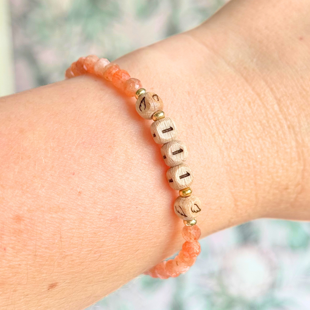 Bracelet featuring engraved wooden 111 angel number and wing beads, on the band of 4mm faceted sunstone round crystal gemstone beads. Finished with your choice of gold vermeil, sterling silver or rose gold vermeil accent beads.