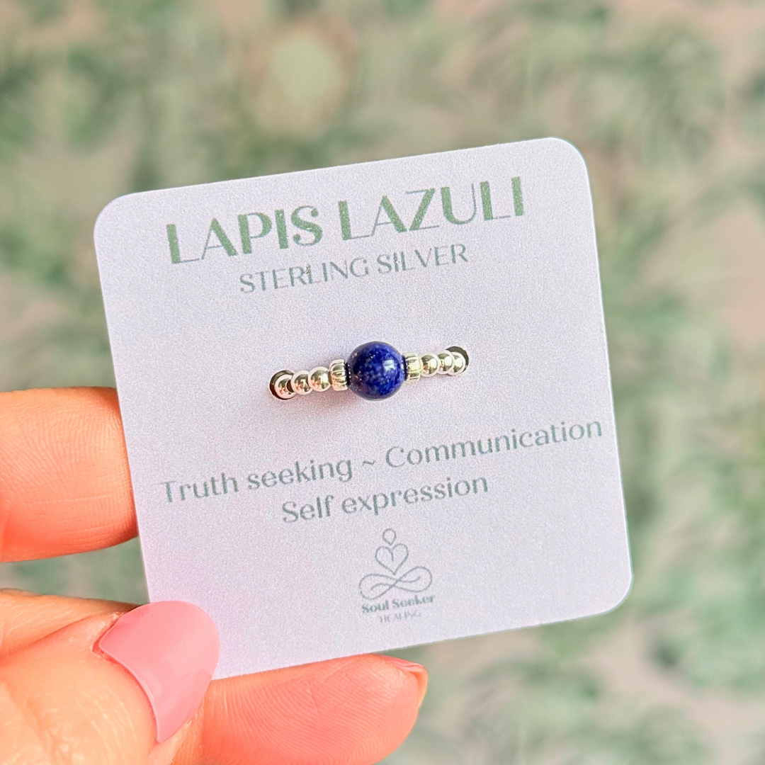 Sterling silver beaded ring featuring a 6mm lapis lazuli round bead, flanked by sterling silver corrugated beads. Elasticated for comfort.