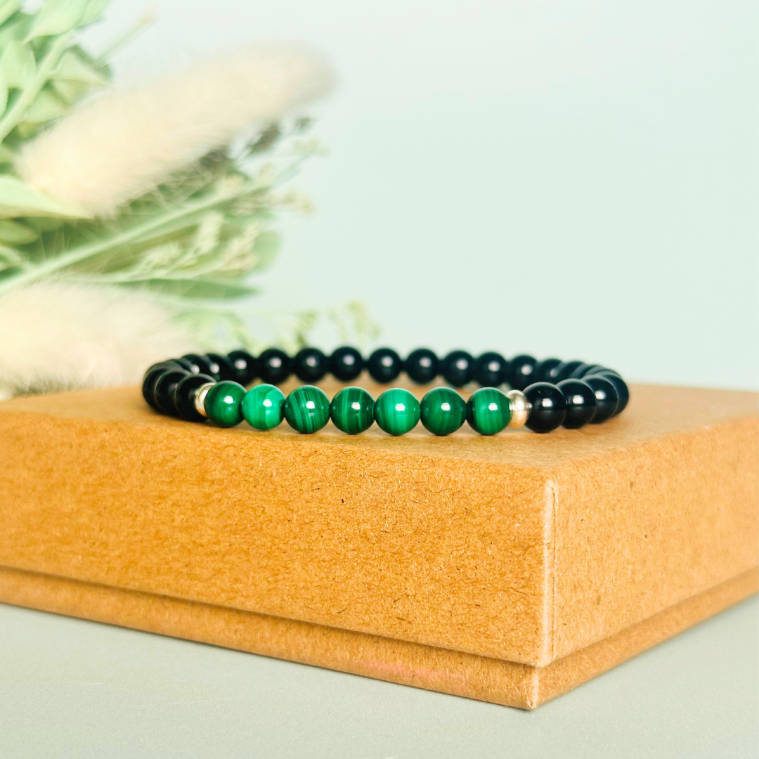 Mens crystal bracelet featuring 6mm black tourmaline beads with 6mm malachite beads, separated by two sterling silver spacer beads.