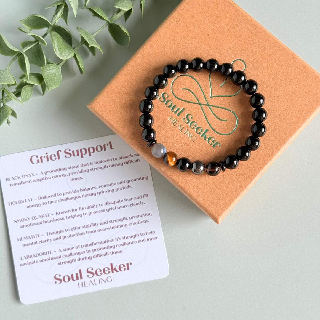 Men’s grief support bracelet featuring 8mm crystal beads which are believed to help with the various aspects of grief and loss. Includes black obsidian, black onyx, labradorite, tigers eye, hematite and smoky quartz.