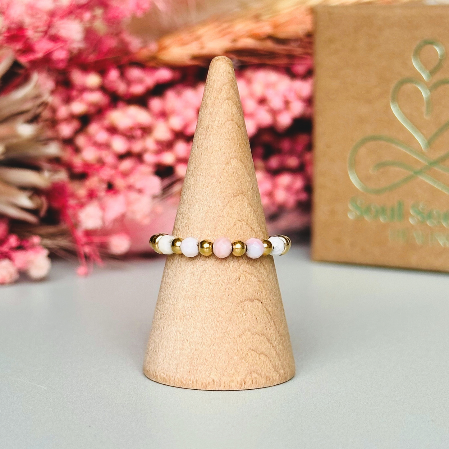 Birthstone ring featuring 5 3mm. Faceted Peruvian pink opal beads on an elasticated band of 3mm gold vermeil round beads, pink opal is an October birth stone so this makes a perfect October birthday gift.