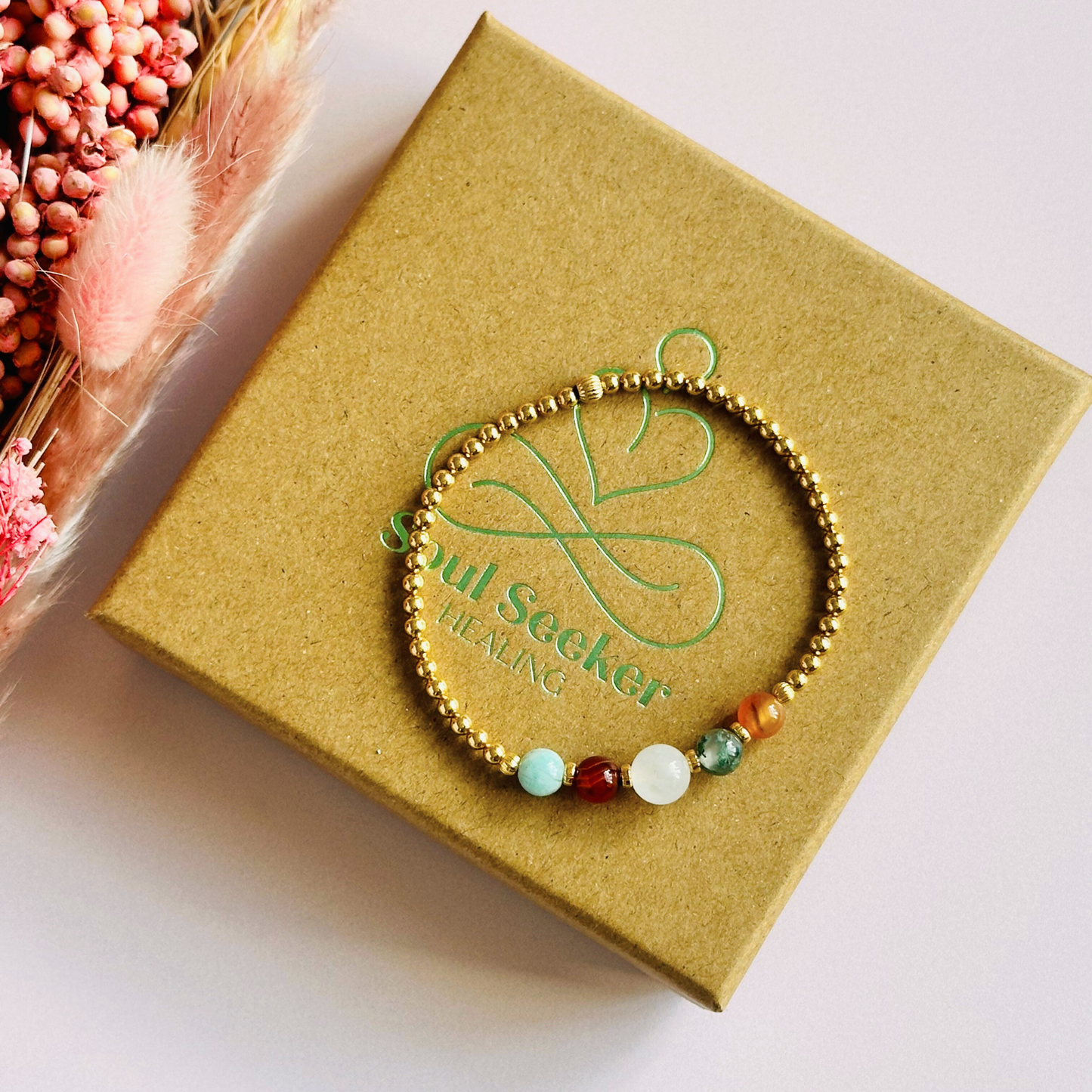 This gold vermeil Virgo bracelet is made with a selection of five healing crystals all believed to resonate with the Virgo zodiac sign. The central bead is 8mm, the other four are 6mm. On an elasticated band of 3mm gold vermeil beads with corrugated accent beads. Featuring amazonite, carnelian, moonstone, moss agate and sardonyx.