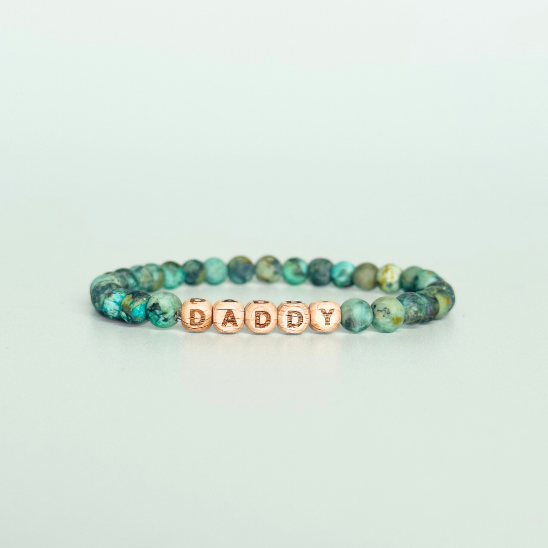 Men’s crystal bracelet with 6mm frosted African turquoise gemstone crystal beads and laser engraved wooden letter beads featuring the words best dad or can also be made with any other words or letters.