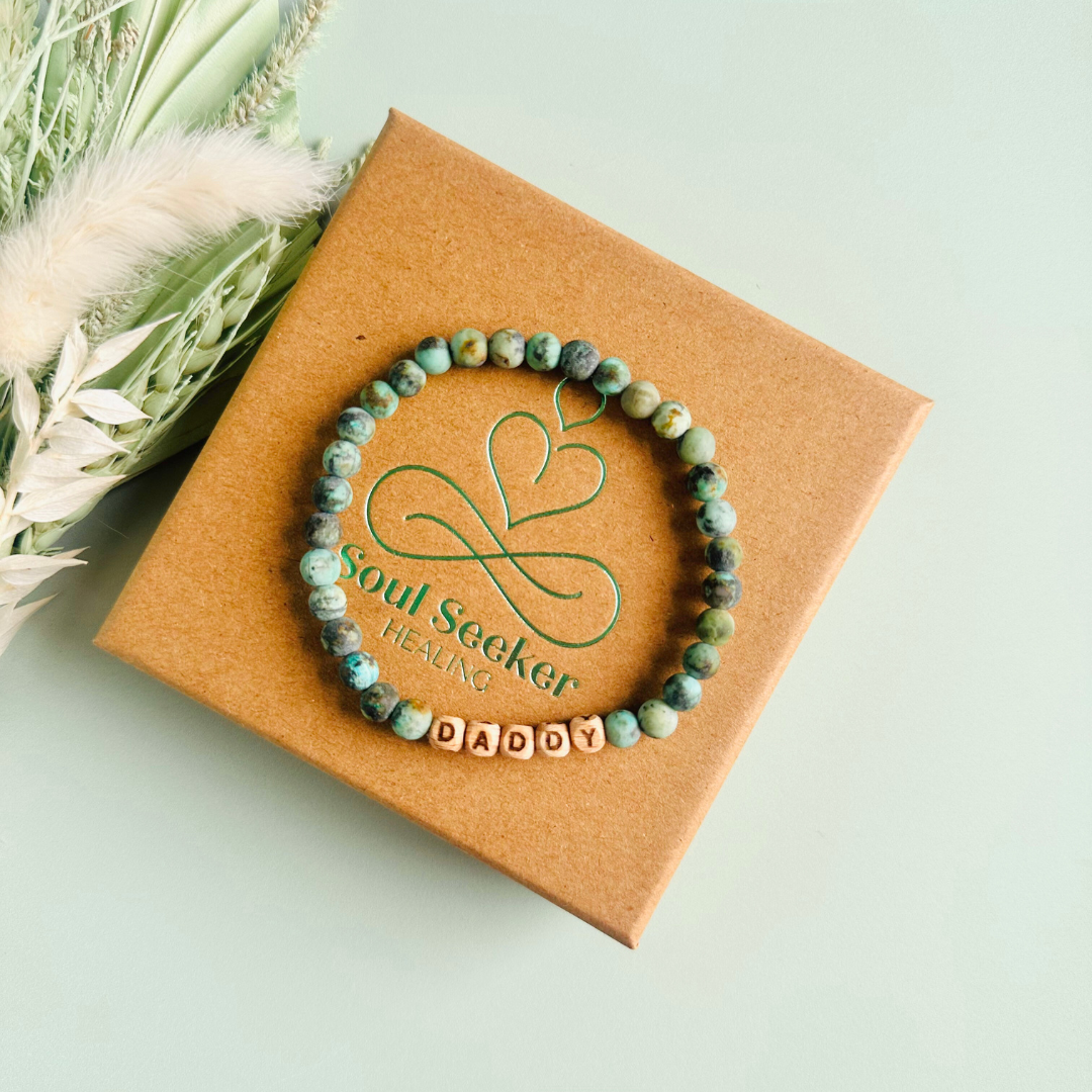 Men’s crystal bracelet with 6mm frosted African turquoise gemstone crystal beads and laser engraved wooden letter beads featuring the words best dad or can also be made with any other words or letters.