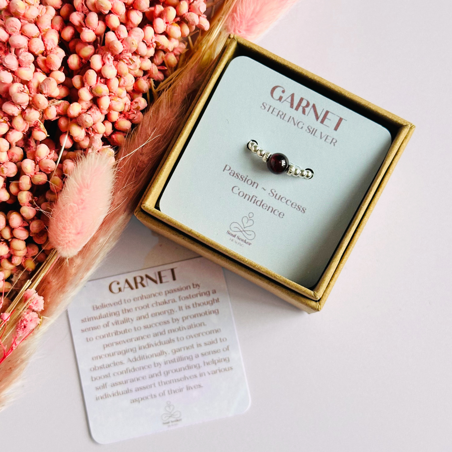 Sterling silver garnet ring featuring a 6mm smooth round garnet bead on a elasticated ring band of 2.5mm sterling silver beads.