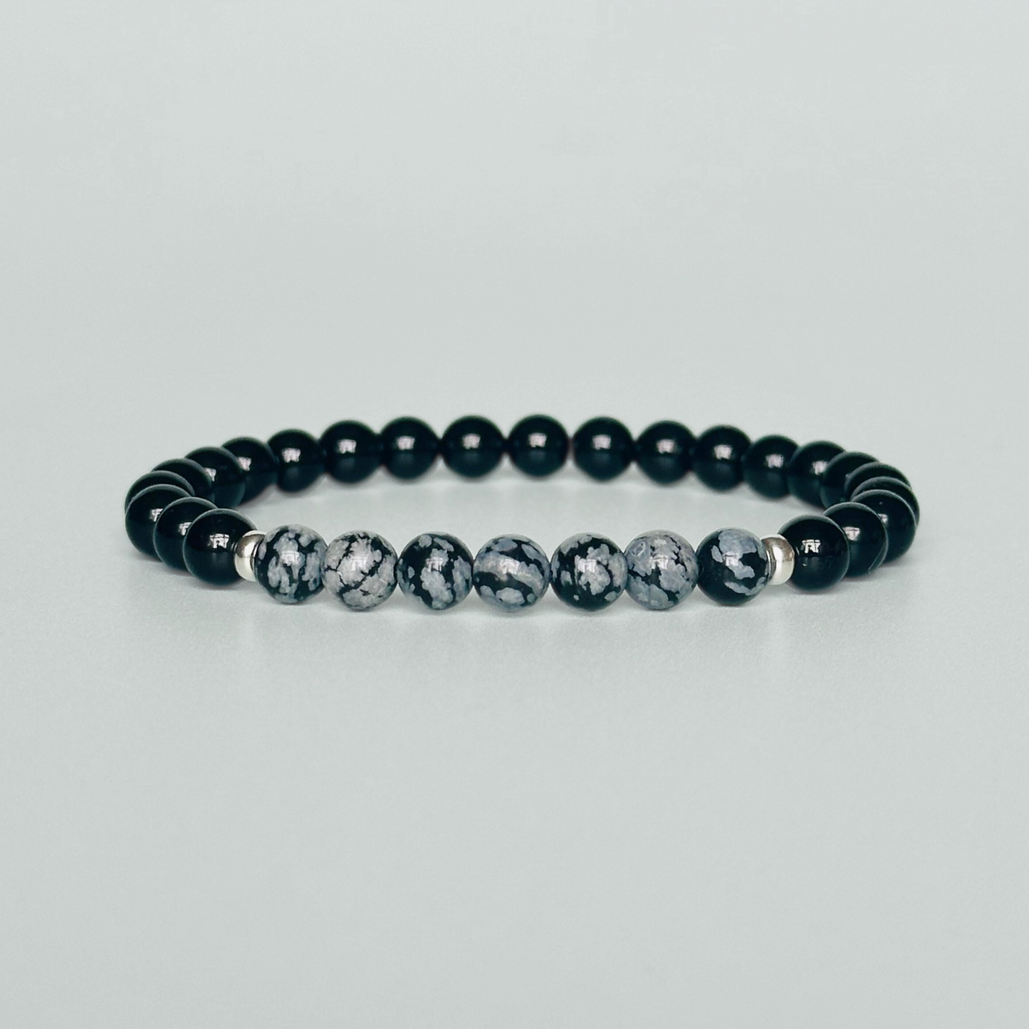 Men’s crystal bracelet featuring 6mm black tourmaline beads, 6mm snowflake obsidian beads with sterling silver spacer beads.