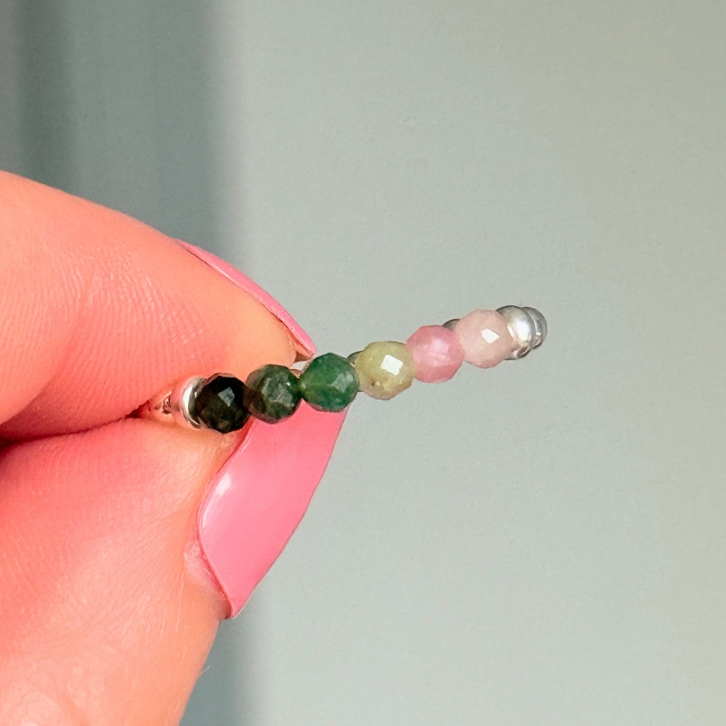 Sterling silver band style ring with multicolour 3mm faceted mixed tourmaline beads in shades of pink, green and black with a beaded band of 2.5 mm sterling silver round . Elasticated for comfort.