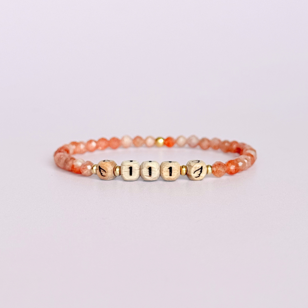 Bracelet featuring engraved wooden 111 angel number and wing beads, on the band of 4mm faceted sunstone round crystal gemstone beads. Finished with your choice of gold vermeil, sterling silver or rose gold vermeil accent beads.
