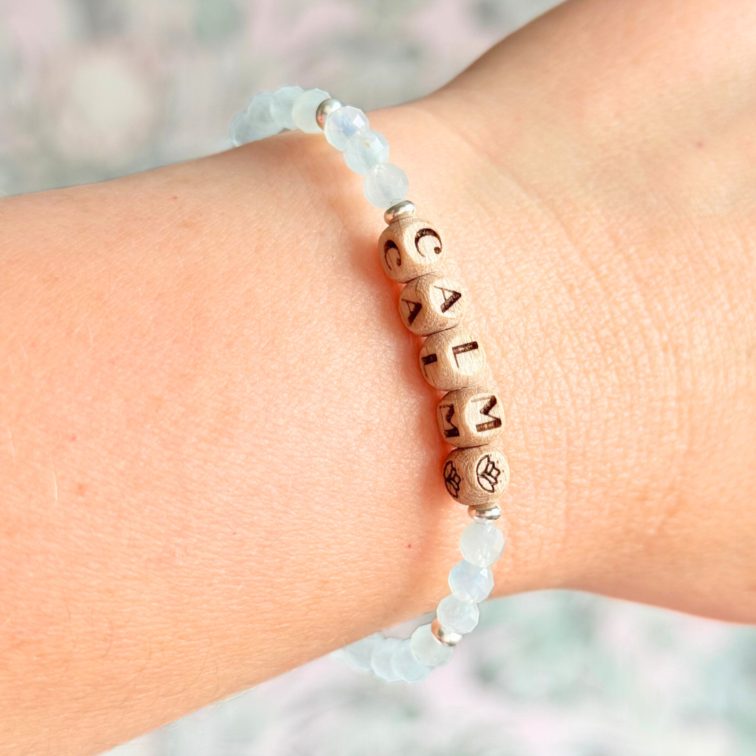 Bracelet featuring 5mm engraved wooden beads which you can personalise with your choice of words, numbers and symbols. The main the band of the bracelet is made with 4mm faceted aquamarine round crystal gemstone beads. Finished with your choice of gold vermeil, sterling silver or rose gold vermeil accent beads.