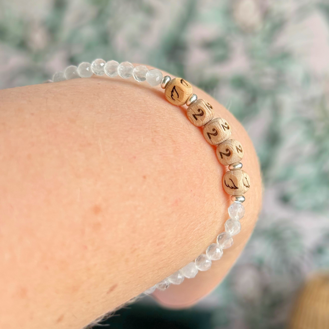 Bracelet featuring engraved wooden 222 angel number and wing beads, on the band of 4mm faceted moonstone round crystal gemstone beads. Finished with your choice of gold vermeil, sterling silver or rose gold vermeil accent beads.