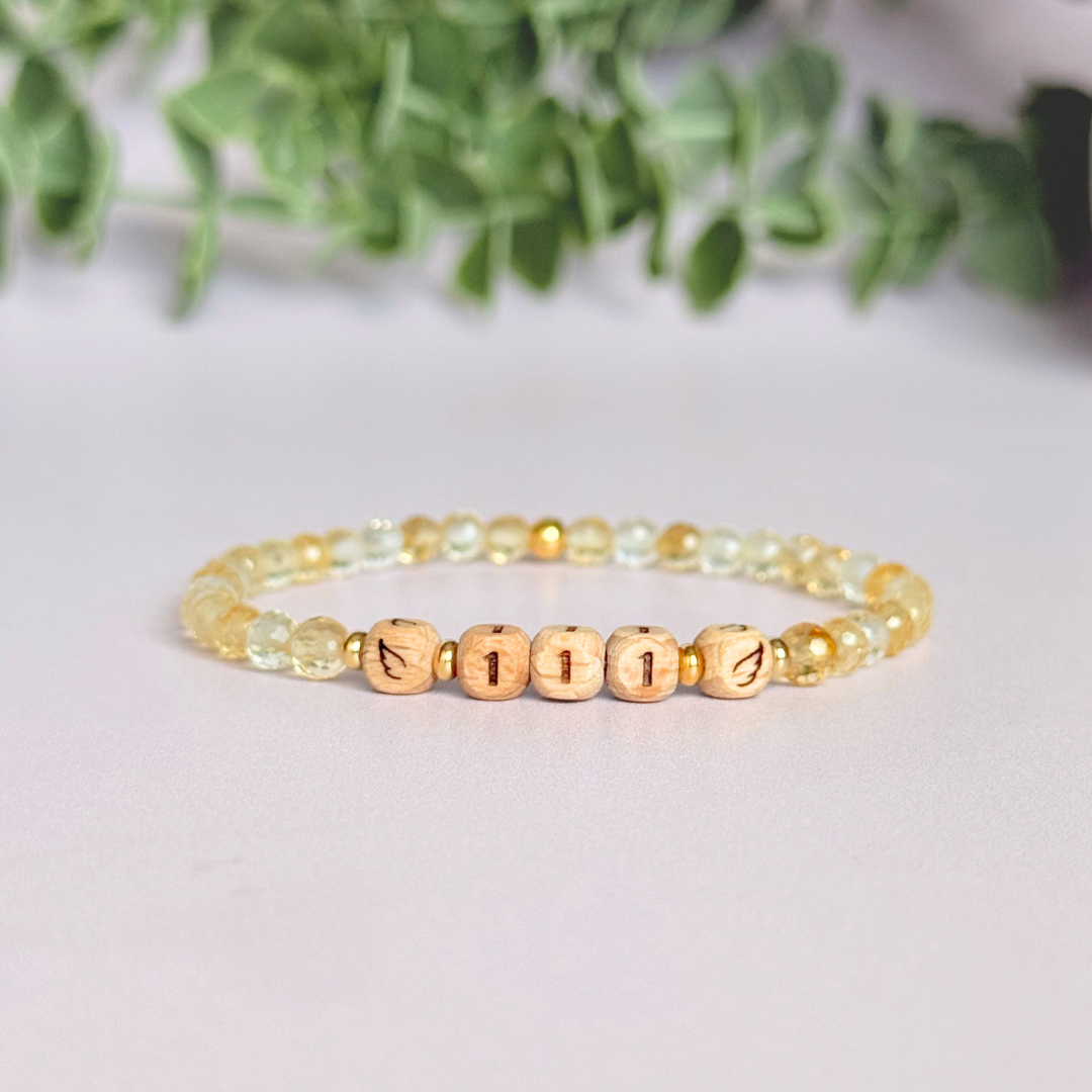 Bracelet featuring engraved wooden 111 angel number and wing beads, on the band of 4mm faceted citrine round crystal gemstone beads. Finished with your choice of gold vermeil, sterling silver or rose gold vermeil accent beads.