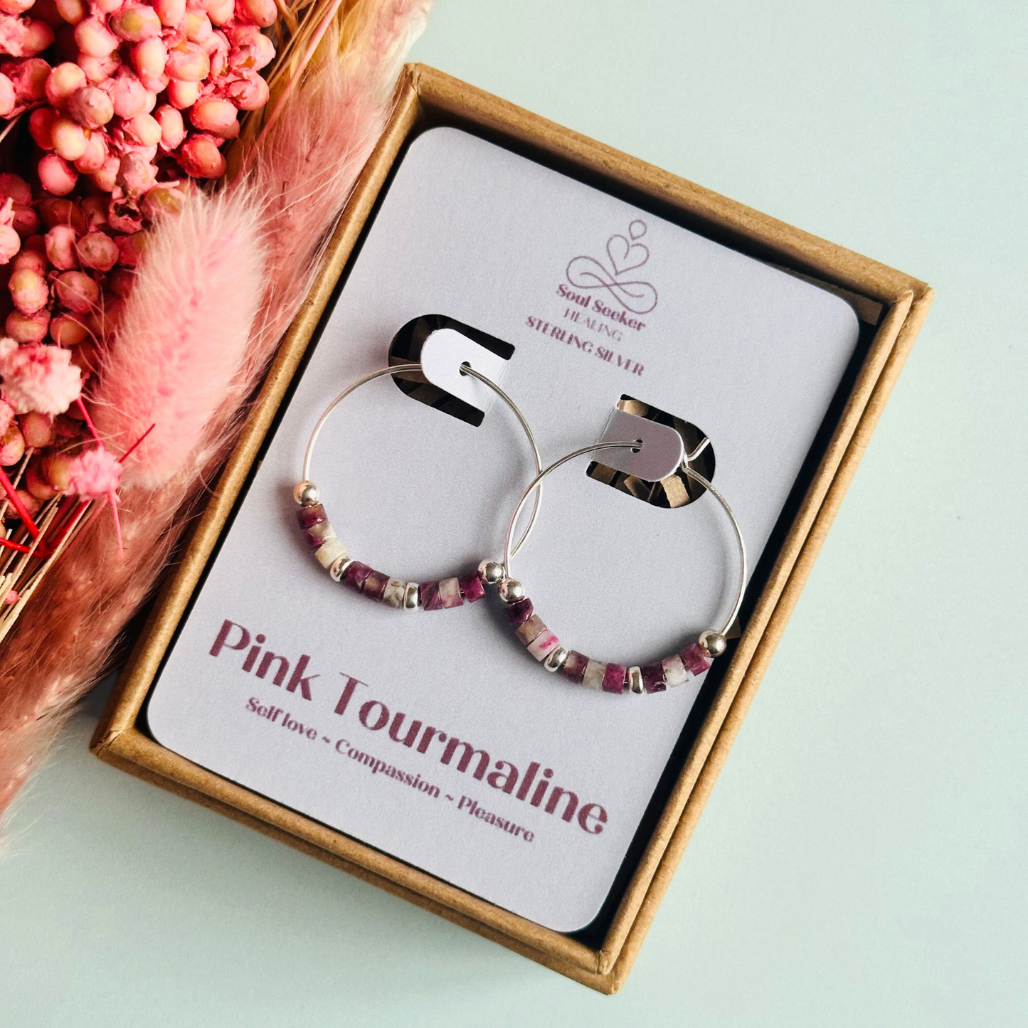 Pink tourmaline sterling silver hoop earrings made with pink tourmaline heishi beads on 25mm sterling silver hoops.