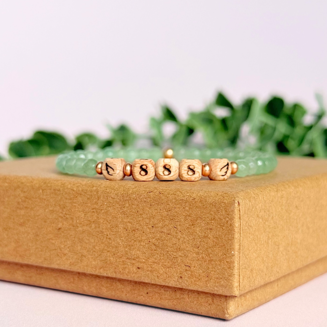 Bracelet featuring engraved wooden 888 angel number and wing beads, on the band of 4mm faceted green aventurine round crystal gemstone beads. Finished with your choice of gold vermeil, sterling silver or rose gold vermeil accent beads.