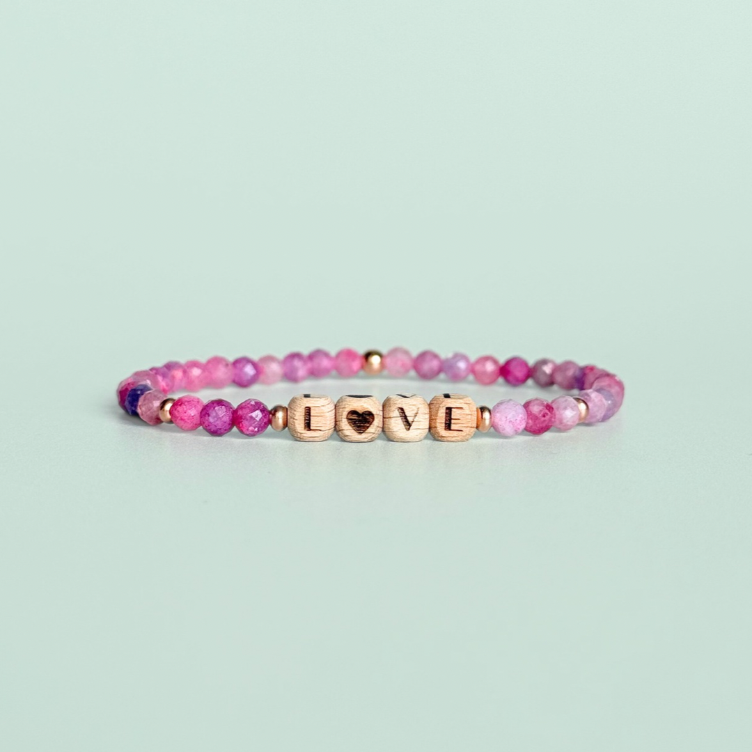 Bracelet featuring 5mm engraved wooden beads which you can personalise with your choice of words, numbers and symbols. The main the band of the bracelet is made with 4mm faceted pink tourmaline round crystal gemstone beads. Finished with your choice of gold vermeil, sterling silver or rose gold vermeil accent beads.