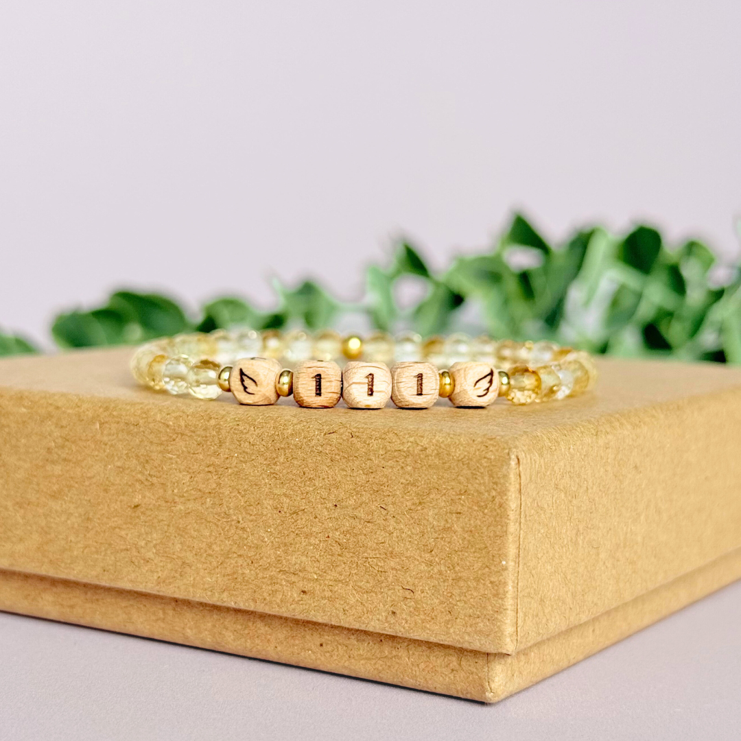 Bracelet featuring engraved wooden 111 angel number and wing beads, on the band of 4mm faceted citrine round crystal gemstone beads. Finished with your choice of gold vermeil, sterling silver or rose gold vermeil accent beads.