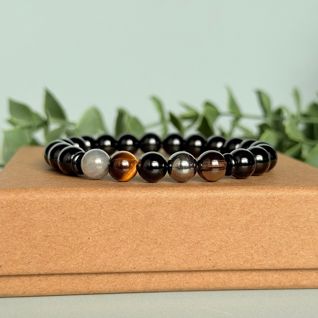 Men’s grief support bracelet featuring 8mm crystal beads which are believed to help with the various aspects of grief and loss. Includes black obsidian, black onyx, labradorite, tigers eye, hematite and smoky quartz.