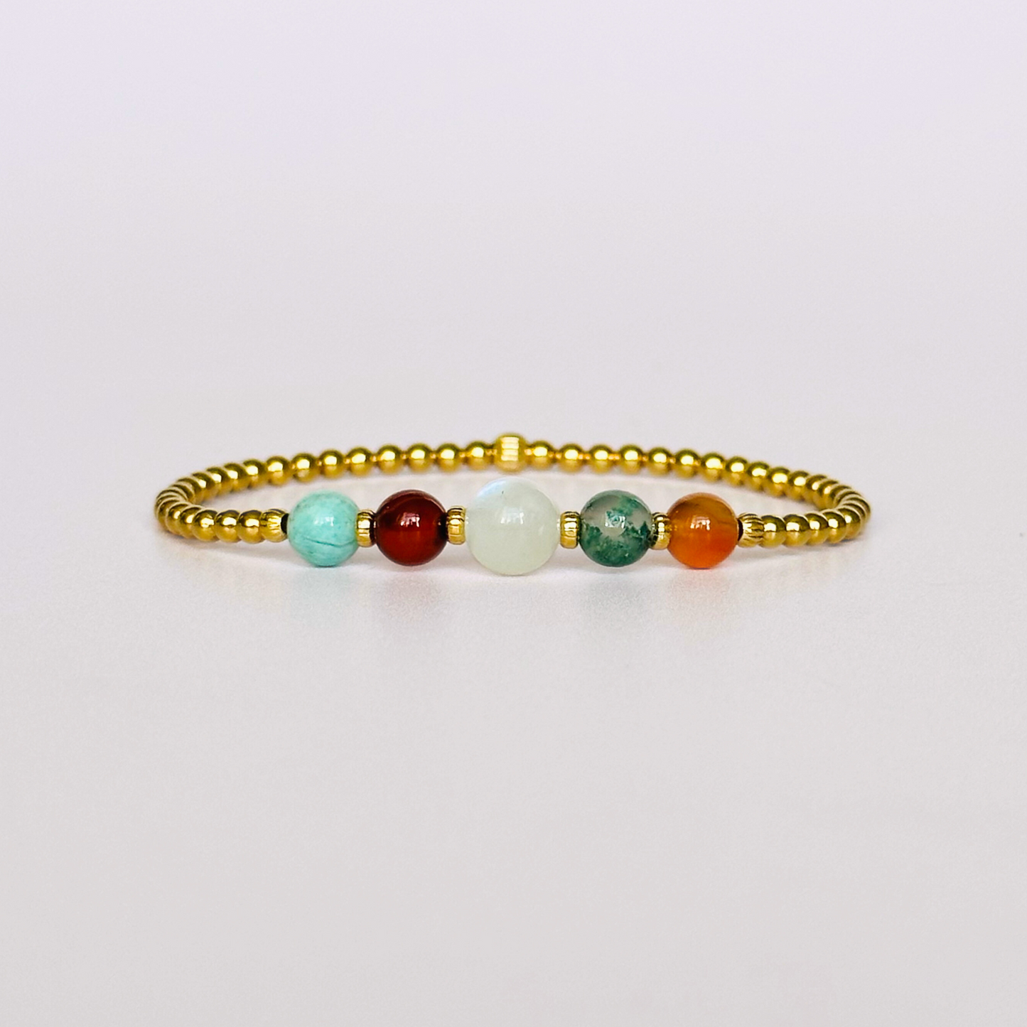 This gold vermeil Virgo bracelet is made with a selection of five healing crystals all believed to resonate with the Virgo zodiac sign. The central bead is 8mm, the other four are 6mm. On an elasticated band of 3mm gold vermeil beads with corrugated accent beads. Featuring amazonite, carnelian, moonstone, moss agate and sardonyx.