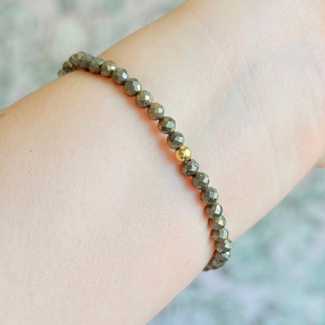 Bracelet featuring engraved wooden 888 angel number and wing beads, on the band of 4mm faceted pyrite round crystal gemstone beads. Finished with your choice of gold vermeil, sterling silver or rose gold vermeil accent beads.