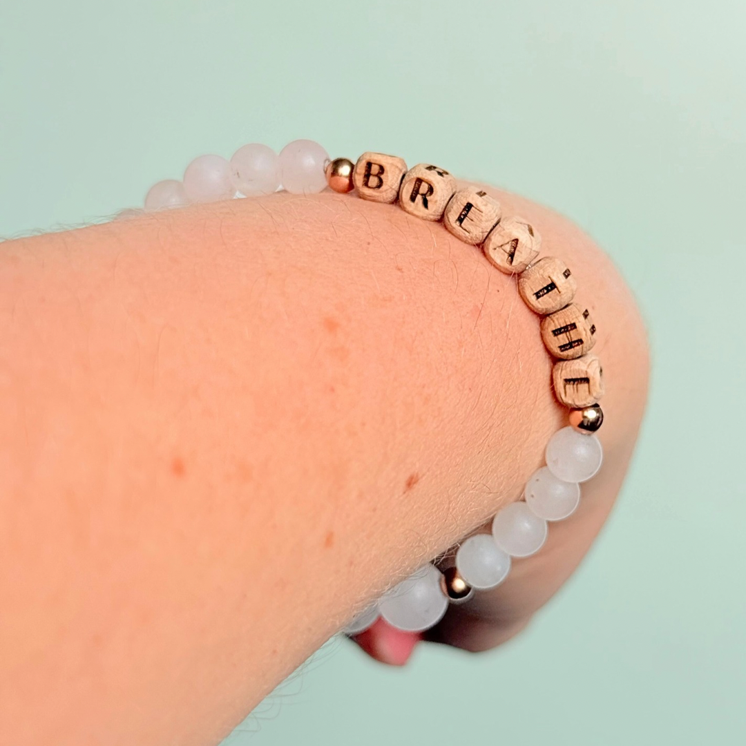 Breathwork bracelet featuring 6mm and 8mm frosted rose quartz crystal beads that follow the 4-7-8 counted breathing method. Also featuring laser engraved wooden letter beads spelling out the word BREATHE. Choose your accent beads from rose gold vermeil, gold vermeil or sterling silver.