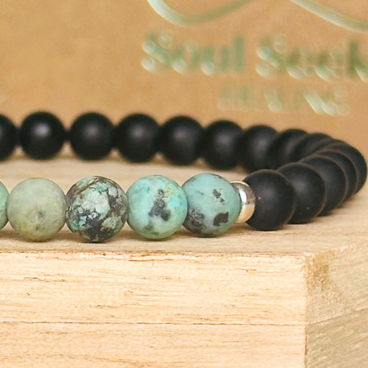 Men’s crystal bracelet featuring 6mm matte black onyx beads, 6mm matte African turquoise beads with sterling silver spacer beads.