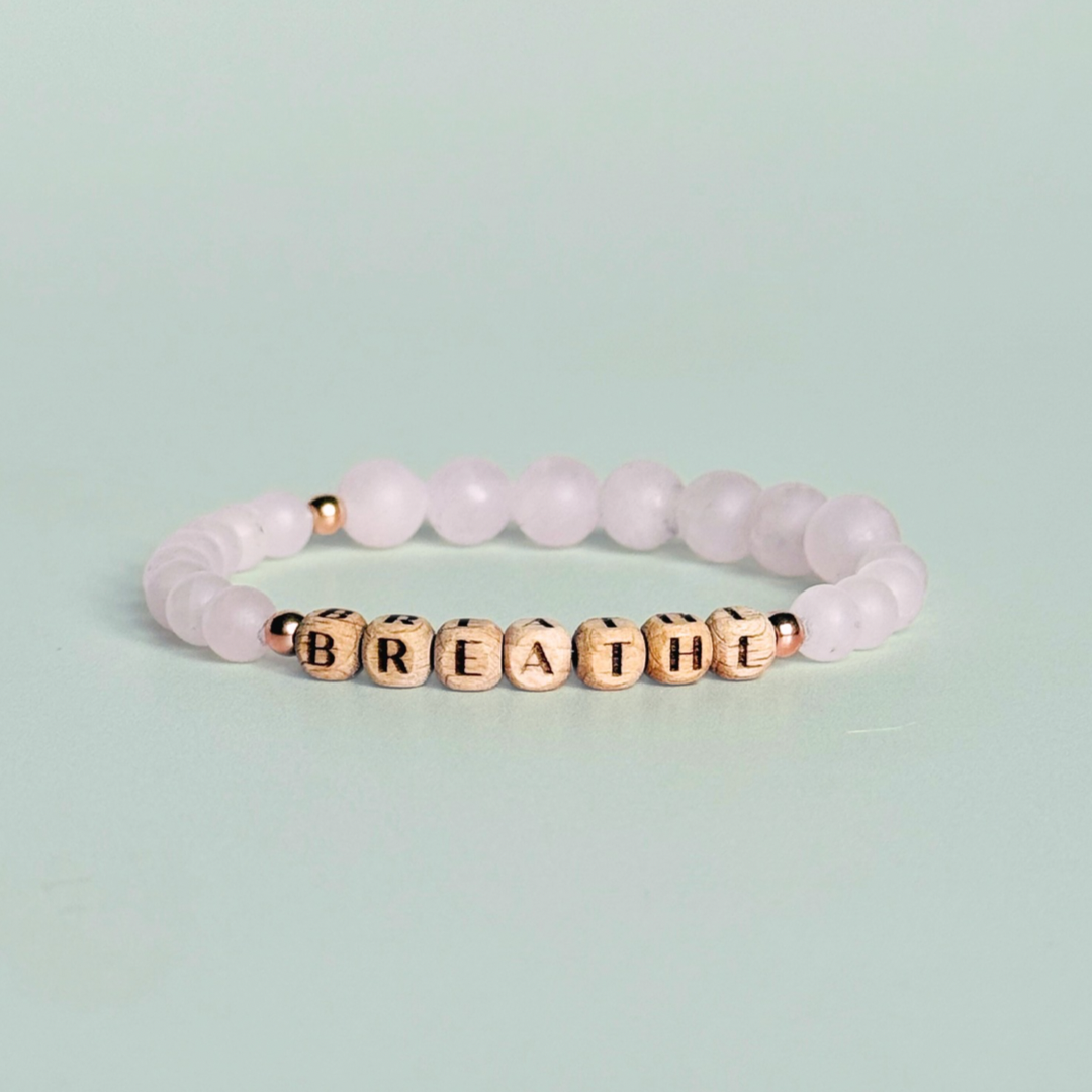 Breathwork bracelet featuring 6mm and 8mm frosted rose quartz crystal beads that follow the 4-7-8 counted breathing method. Also featuring laser engraved wooden letter beads spelling out the word BREATHE. Choose your accent beads from rose gold vermeil, gold vermeil or sterling silver.