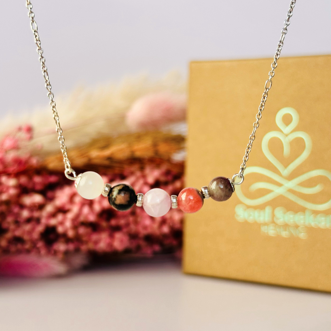 A dainty self love crystal necklace made with a selection of five healing crystals all believed to help promote self love. On a fine, sterling silver figaro chain, which fastens with a sterling silver bolt clasp. Featuring corrugated sterling silver spacer beads and accented with daisy shaped bead caps.