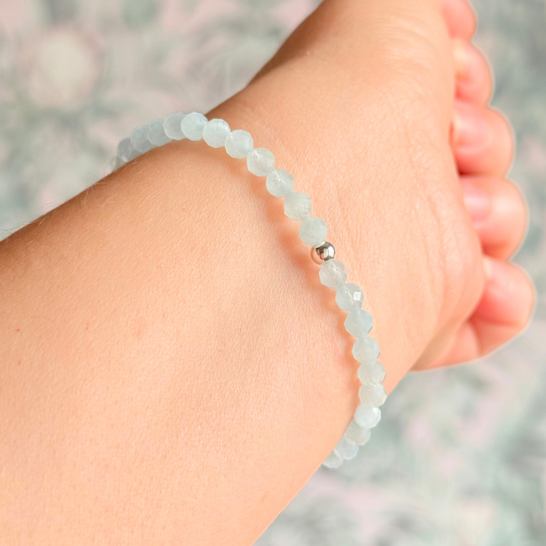 Bracelet featuring 5mm engraved wooden beads which you can personalise with your choice of words, numbers and symbols. The main the band of the bracelet is made with 4mm faceted aquamarine round crystal gemstone beads. Finished with your choice of gold vermeil, sterling silver or rose gold vermeil accent beads.