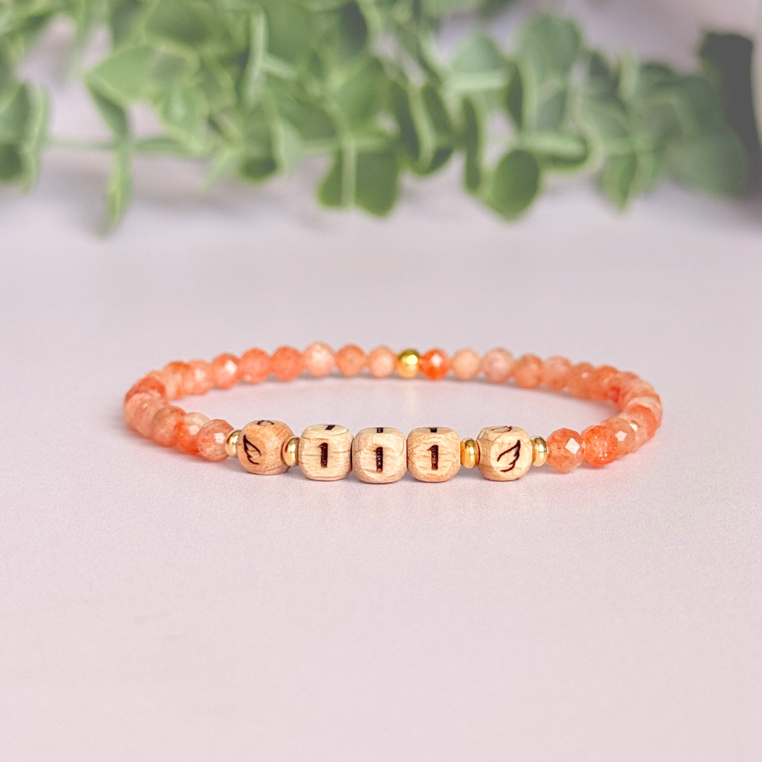 Bracelet featuring engraved wooden 111 angel number and wing beads, on the band of 4mm faceted sunstone round crystal gemstone beads. Finished with your choice of gold vermeil, sterling silver or rose gold vermeil accent beads.