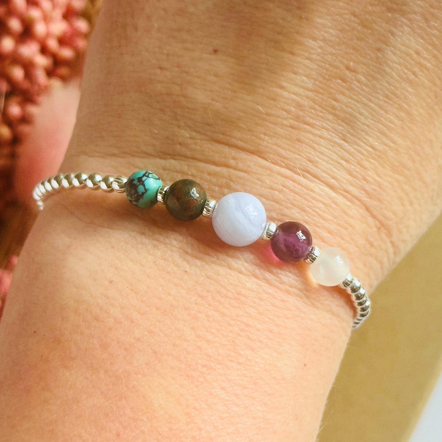This sterling silver Pisces bracelet is made with a selection of five healing crystals all believed to resonate with the Pisces zodiac sign. The central bead is 8mm, the other four are 6mm. On an elasticated band of 3mm sterling silver beads with corrugated accent beads. Featuring turquoise, bloodstone, blue lace agate, amethyst and selenite.