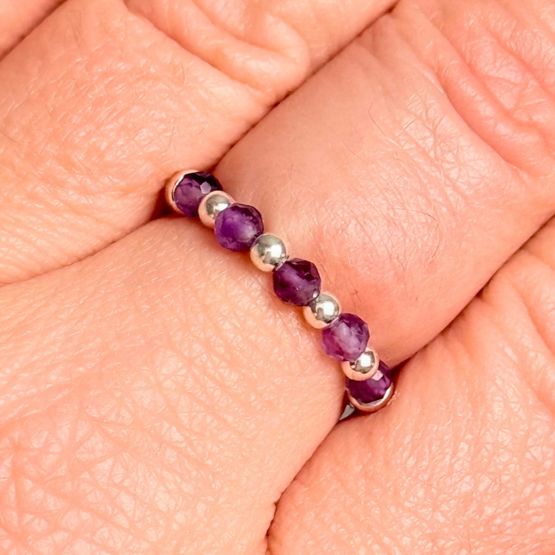 Sterling silver amethyst ring featuring five 3mm faceted round amethyst beads on a elasticated ring band of 2.5mm sterling silver beads. February birthstone ring.