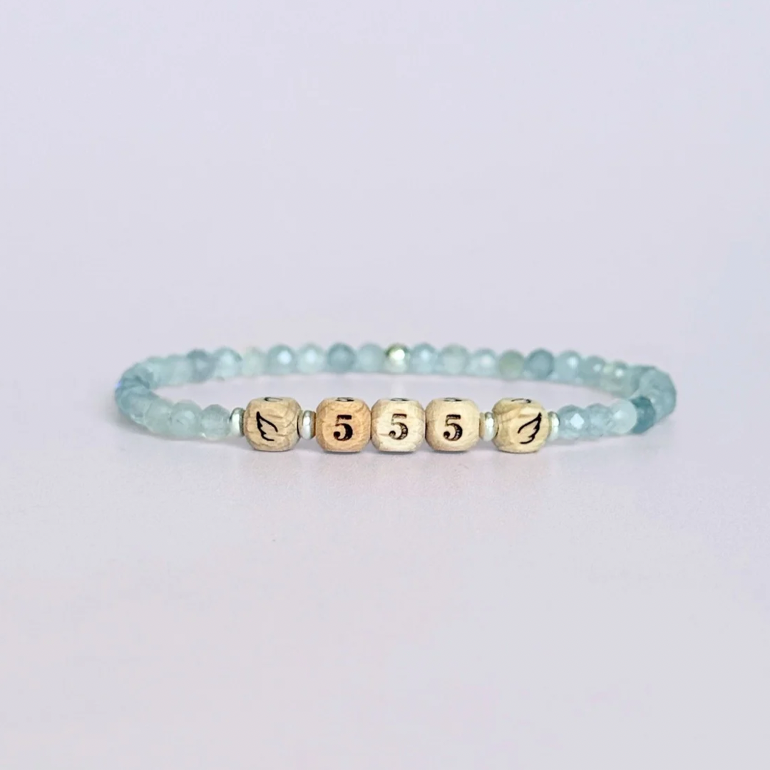 Bracelet featuring engraved wooden 555 angel number and wing beads, on the band of 4mm faceted labradorite round crystal gemstone beads. Finished with your choice of gold vermeil, sterling silver or rose gold vermeil accent beads.