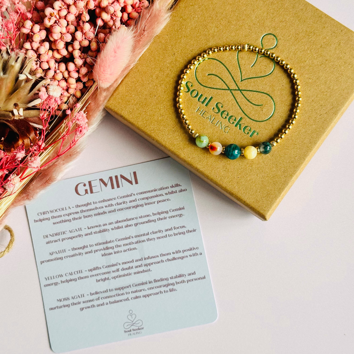 This gold vermeil Gemini bracelet is made with a selection of five healing crystals all believed to resonate with the Gemini zodiac sign. The central bead is 8mm, the other four are 6mm. On an elasticated band of 3mm gold vermeil beads with corrugated accent beads. Featuring chrysocolla, dendritic agate, apatite, yellow calcite and moss agate.