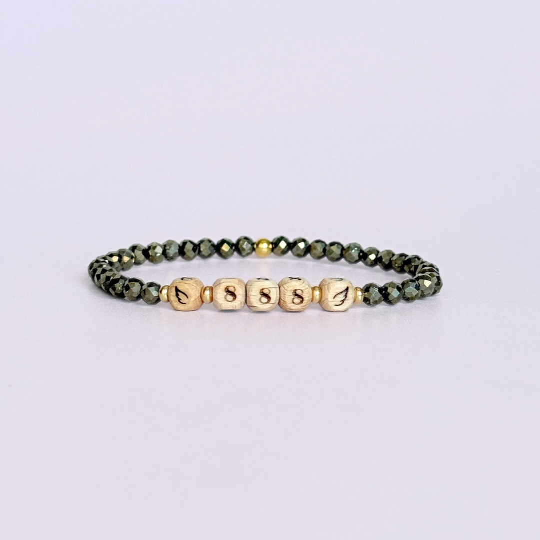 Bracelet featuring engraved wooden 888 angel number and wing beads, on the band of 4mm faceted pyrite round crystal gemstone beads. Finished with your choice of gold vermeil, sterling silver or rose gold vermeil accent beads.