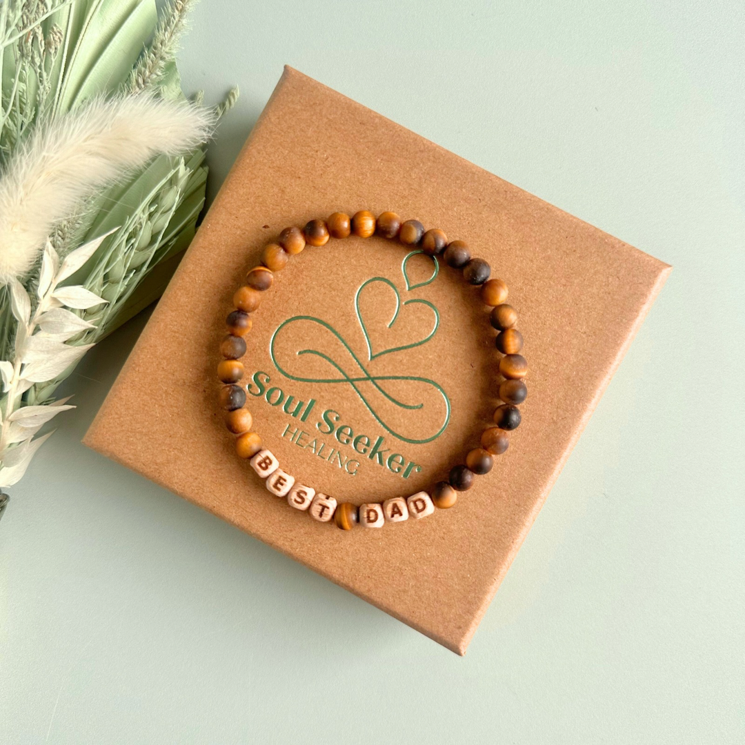 Men’s crystal bracelet with 6mm frosted tigers eye gemstone crystal beads and laser engraved wooden letter beads featuring the words best dad or can also be made with any other words or letters.