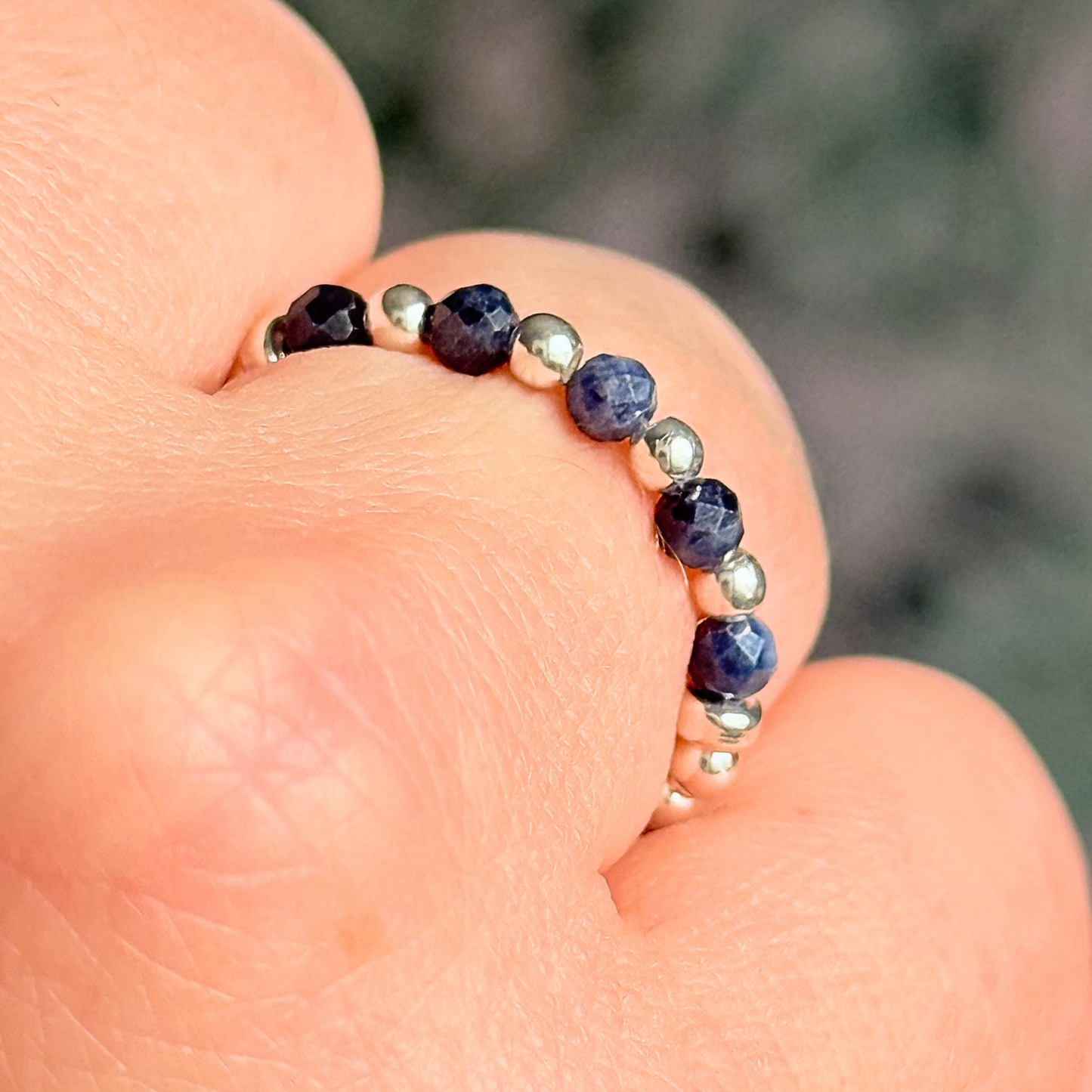 Sterling silver and sapphire crystal ring. Made with 2.5 mm sterling silver round beads and featuring five, 3mm faceted genuine sapphire beads in a band style. Perfect for stacking. September birthstone jewellery