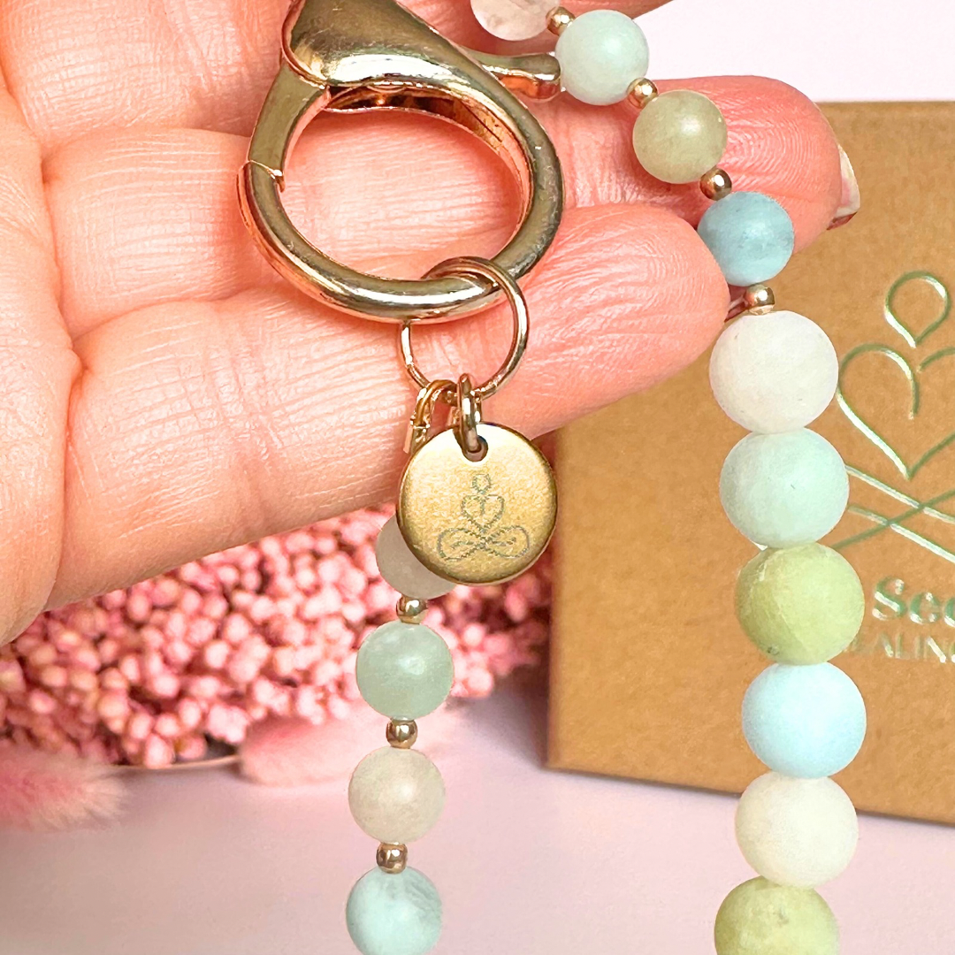 Frosted morganite breath work beads on a rose gold keychain/bag charm. For the 4-7-8 counted breathing method.