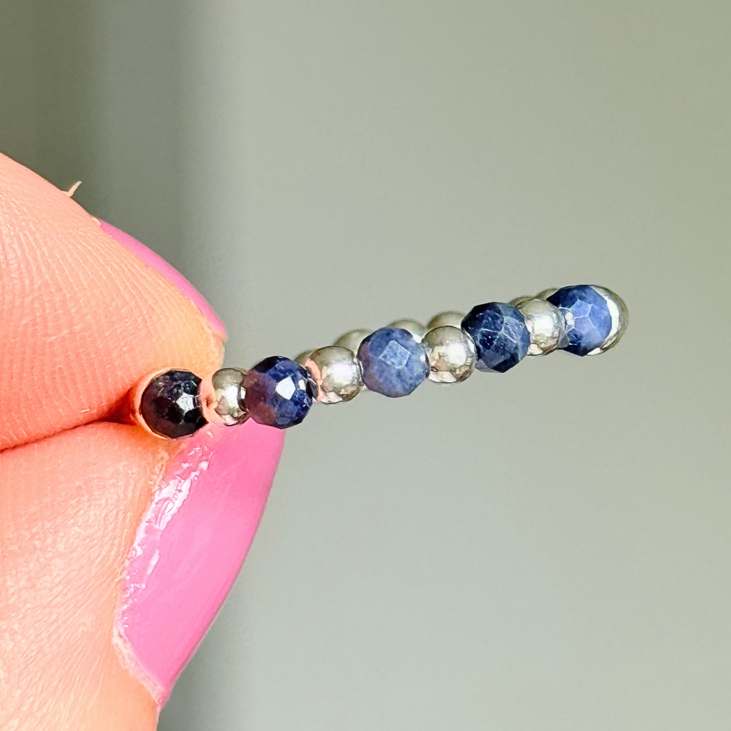 Sterling silver and sapphire crystal ring. Made with 2.5 mm sterling silver round beads and featuring five, 3mm faceted genuine sapphire beads in a band style. Perfect for stacking. September birthstone jewellery