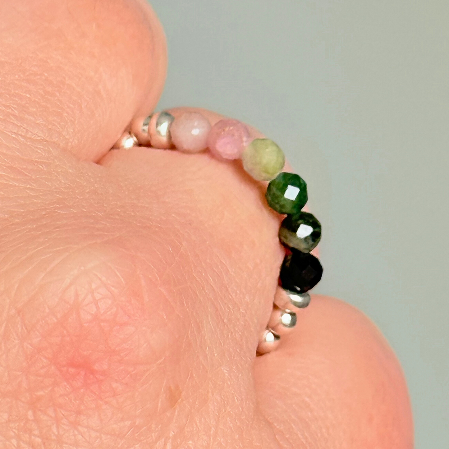 Sterling silver band style ring with multicolour 3mm faceted mixed tourmaline beads in shades of pink, green and black with a beaded band of 2.5 mm sterling silver round . Elasticated for comfort.