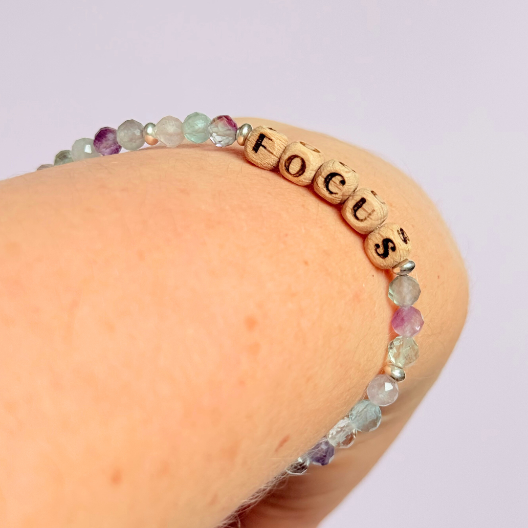 Bracelet featuring 5mm engraved wooden beads, which you can personalise with your choice of words, numbers and symbols. The main the band of the bracelet is made with 4mm faceted fluorite round crystal gemstone beads. Finished with your choice of gold vermeil, sterling silver or rose gold vermeil accent beads.