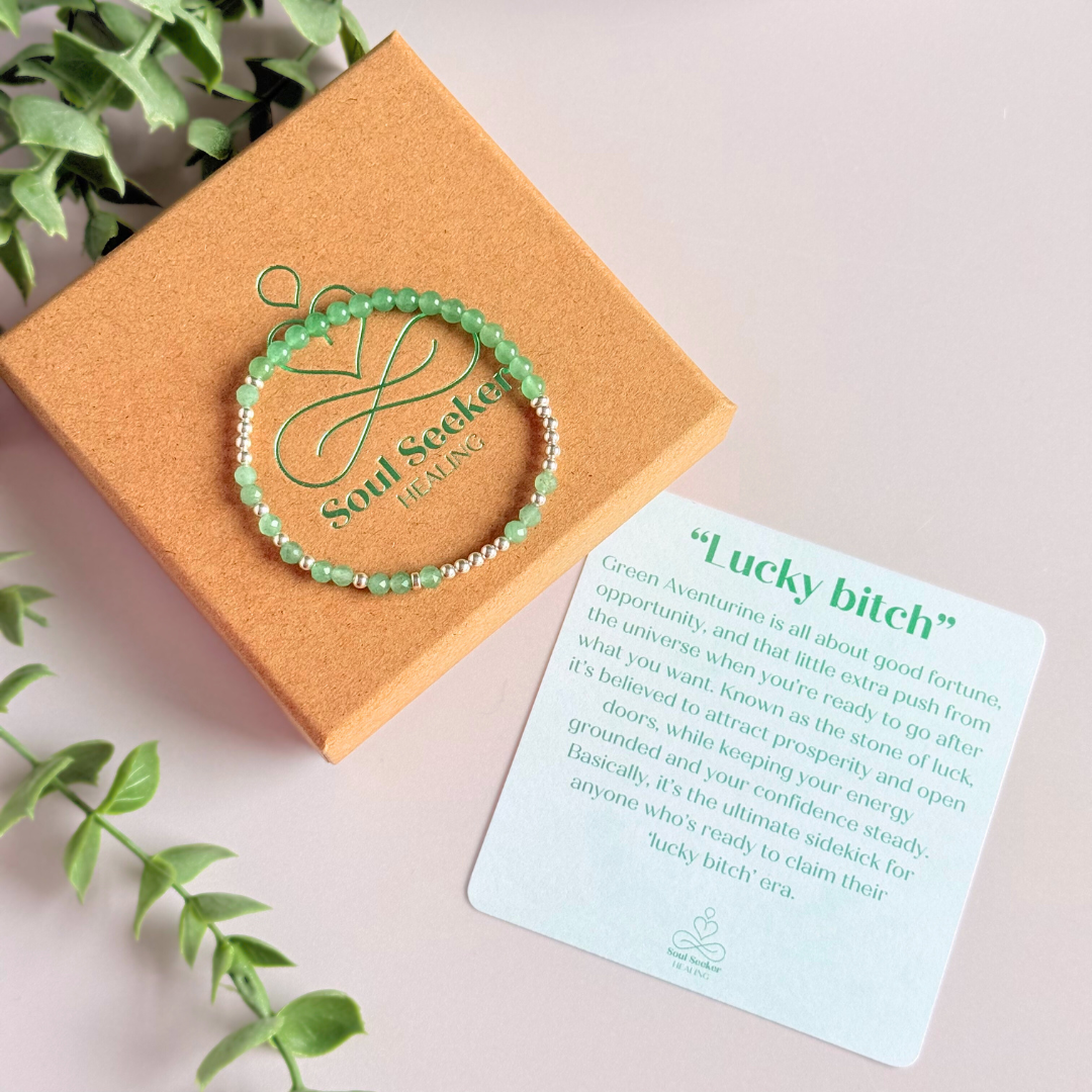 Elasticated green aventurine crystal morse code bracelet spells out the words ‘Lucky bitch’ in a combination of 4mm round green aventurine beads, 4mm faceted green aventurine beads and either sterling silver or gold vermeil 3mm round beads. The words start and end at the rondelle spacer beads.