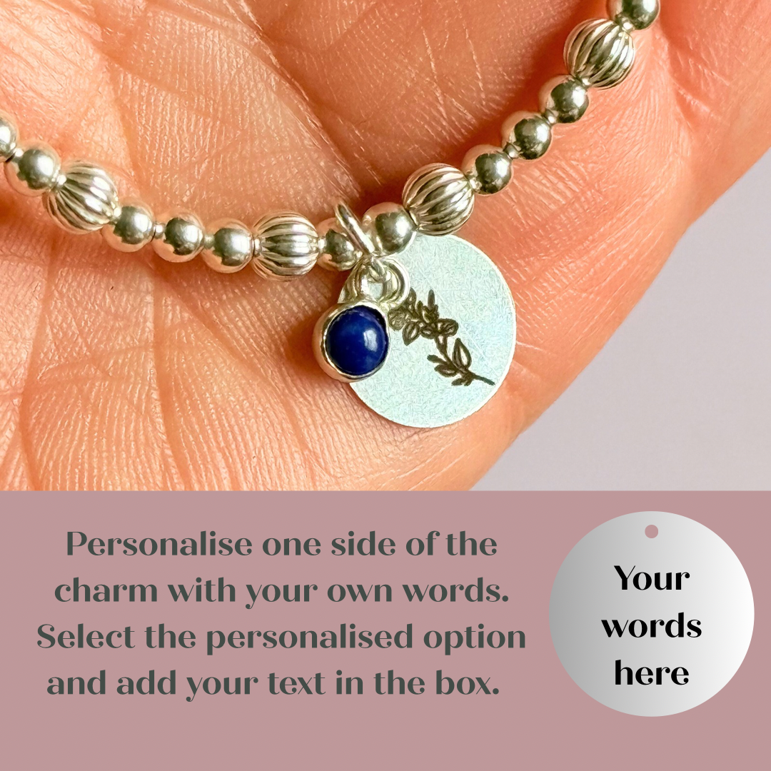 This sterling silver bracelet features a domed 4mm lapis lazuli cabochon charm, the birth stone for September, in a sterling silver setting. It features an 11mm sterling silver disc charm, which is engraved with the September birth flower, Morning Glory. This charm can be personalised on one side if required or feature the same flower graphic on both sides. The main band of the bracelet is made up of 3 mm sterling silver round ball beads with some corrugated accent beads.