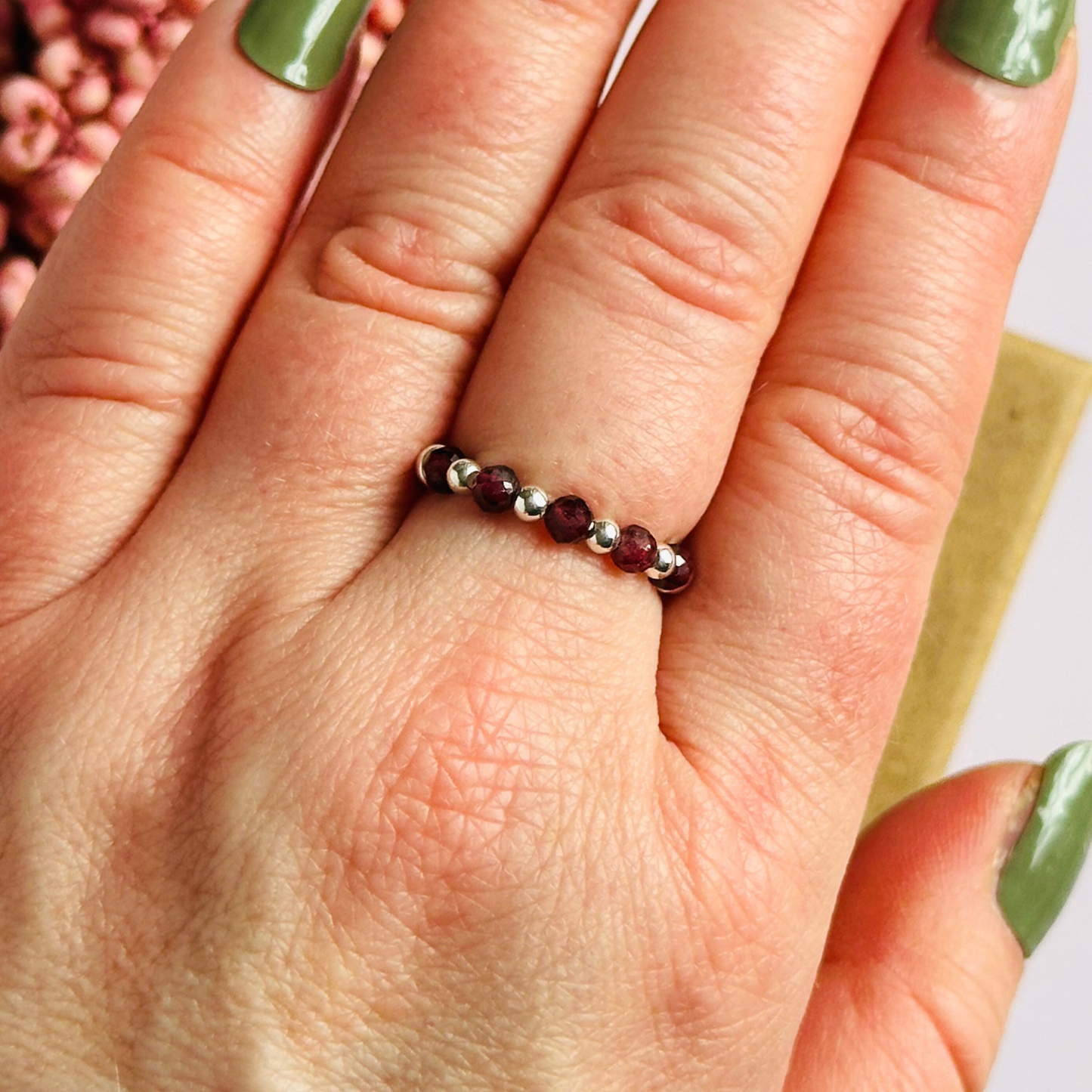 Sterling silver garnet band ring featuring five 3mm faceted round ethically sourced garnet beads, surrounded by sterling silver rondelle beads and delicate 2.5mm sterling silver beads. January birthstone ring.