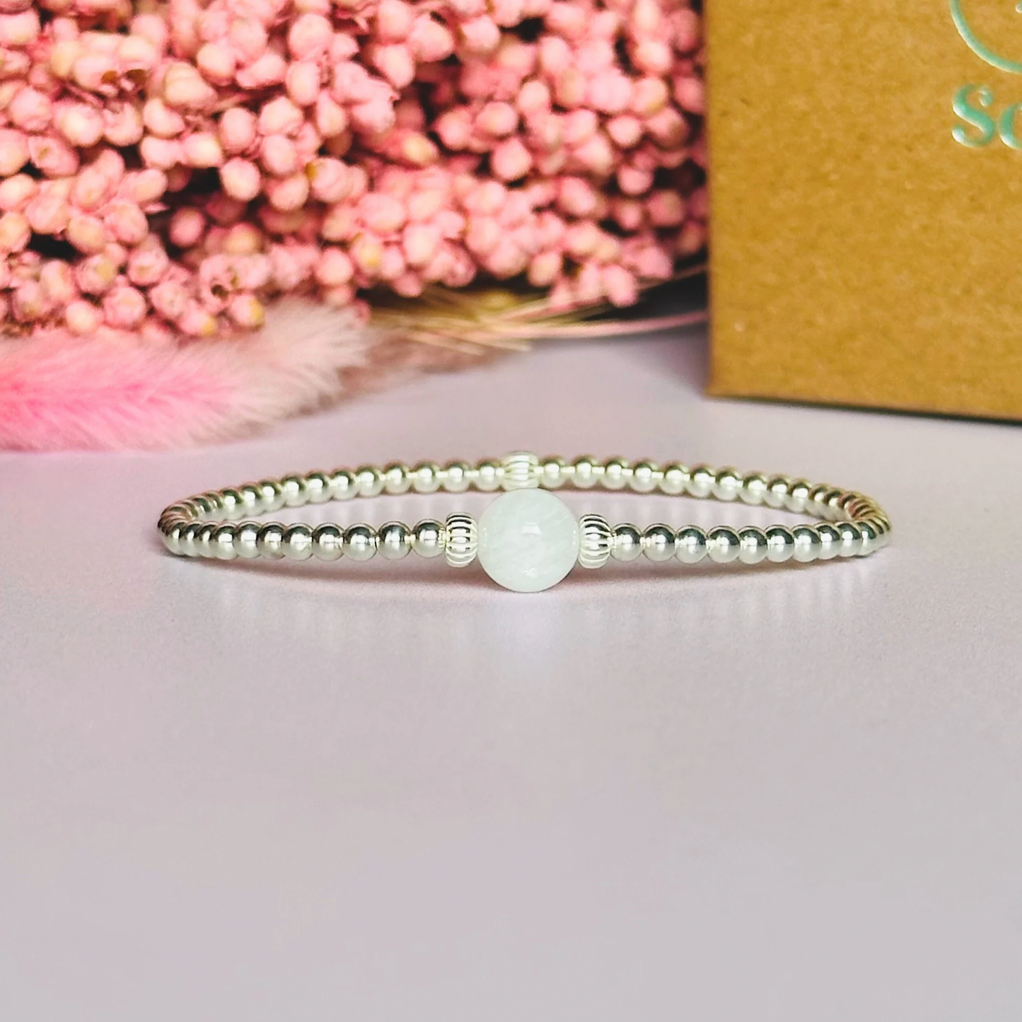 Sterling silver moonstone bracelet features an ethically mined 8mm moonstone bead, flanked by corrugated rondelle beads on a band of 3mm sterling silver beads. A bracelet to promote feminine energy and intuition.
