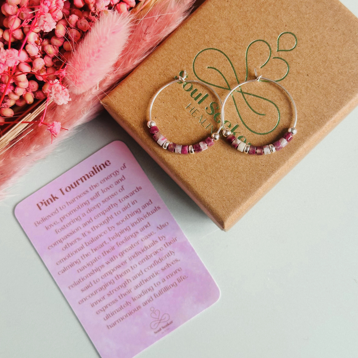 Pink tourmaline sterling silver hoop earrings made with pink tourmaline heishi beads on 25mm sterling silver hoops.