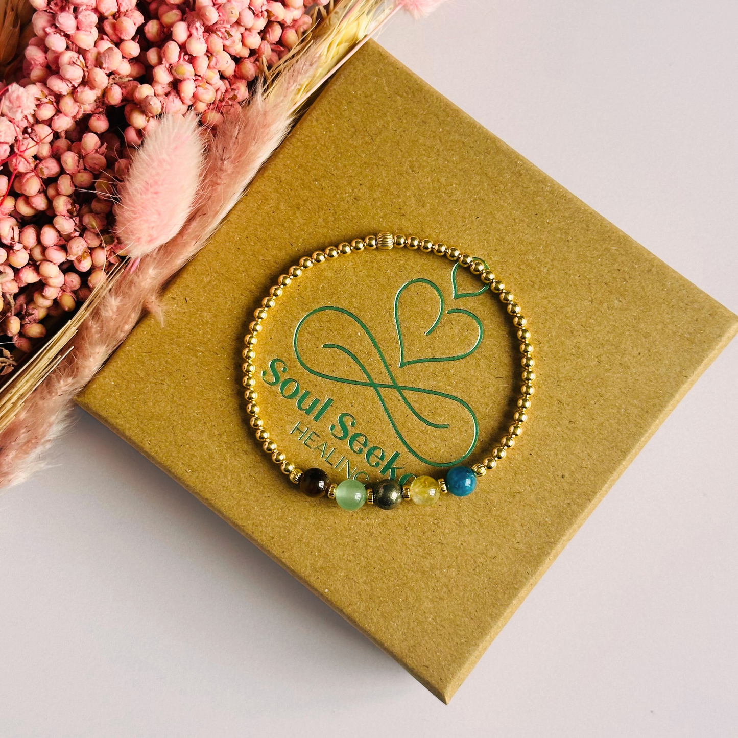 This gold vermeil manifesting bracelet is made with a selection of five healing crystals all believed to help achieve your dream life. The crystal beads are all 6mm and are on a band of 3mm gold vermeil beads with corrugated accent beads.